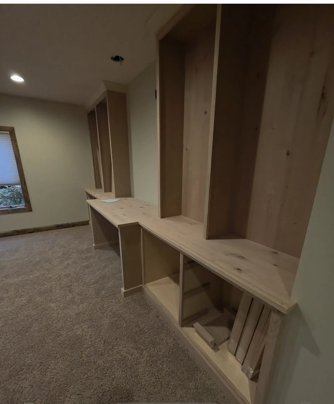 Custom wooden built-in shelving and countertop before final finishing