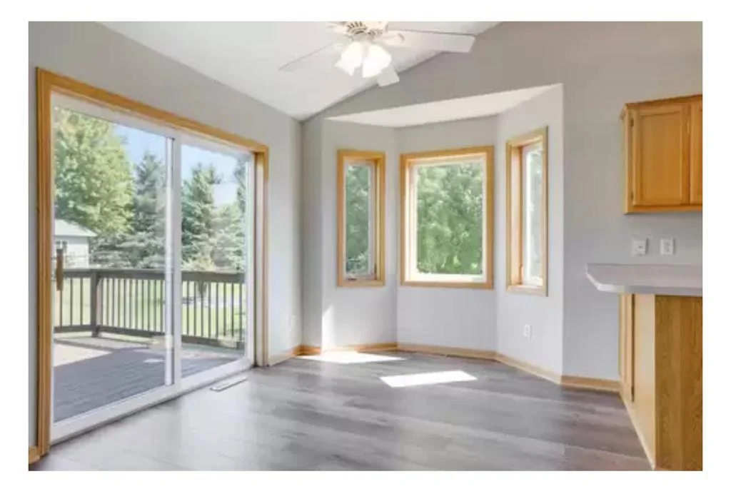 Dining area with natural oak trim and cabinetry before a brighter finish