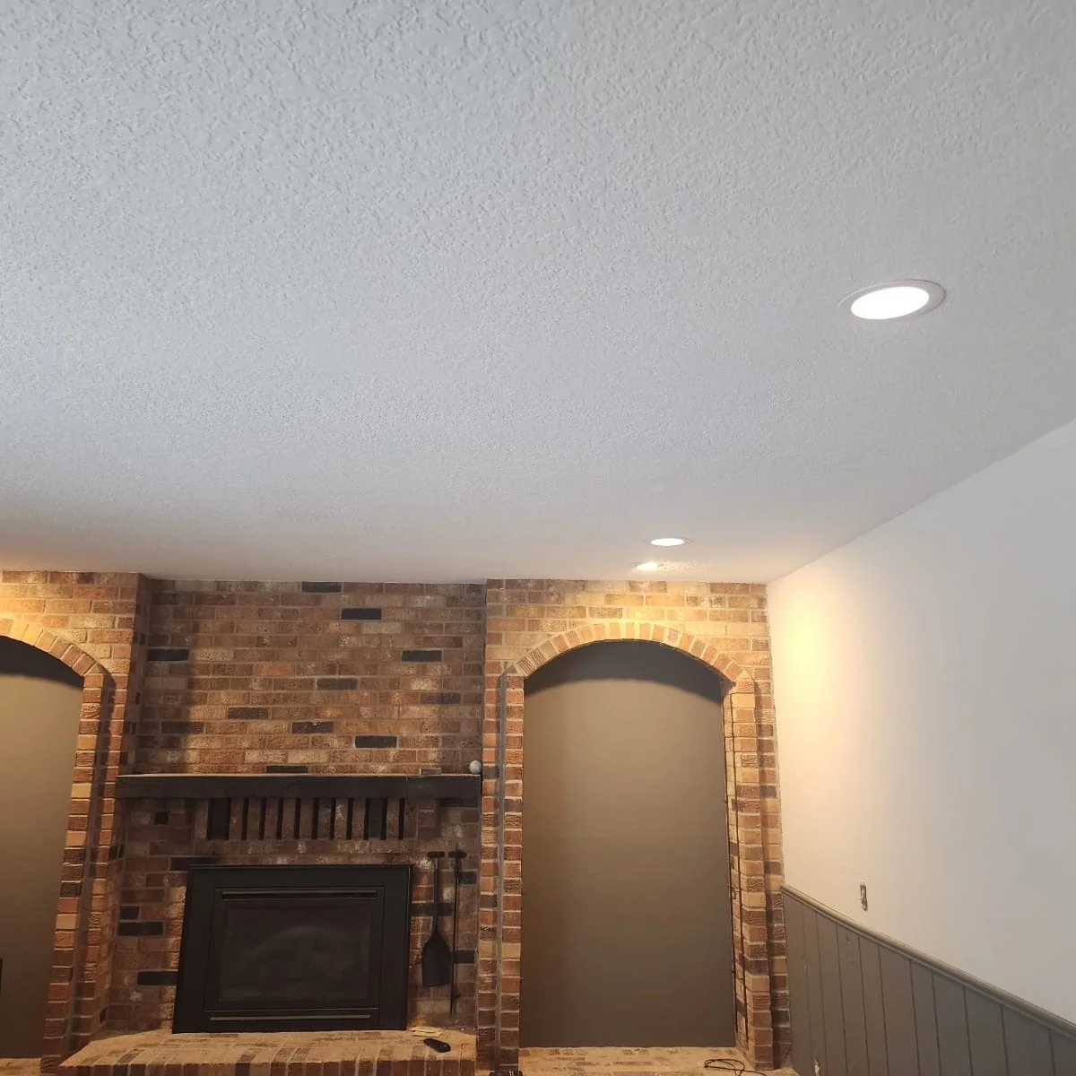 Ceiling texture blending and patch repair in front of a brick fireplace
