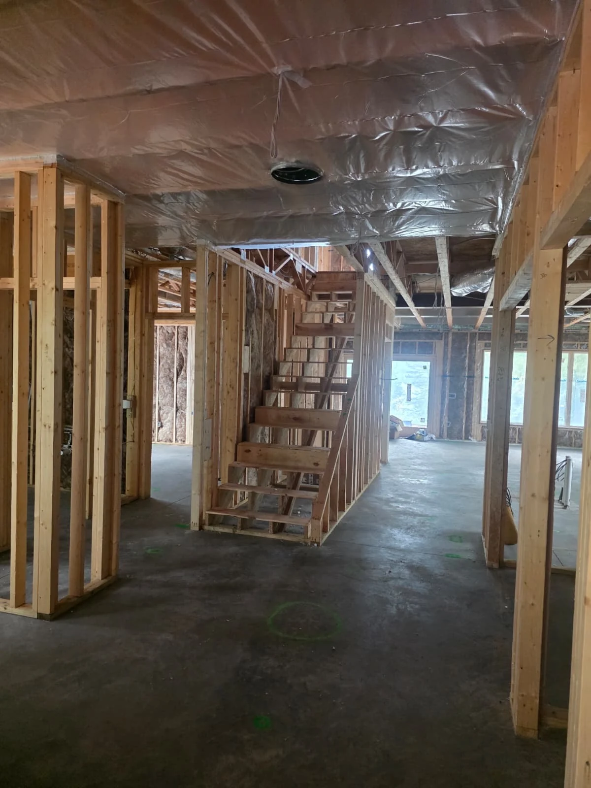 Wood-framed stairwell and interior partitions before drywall installation
